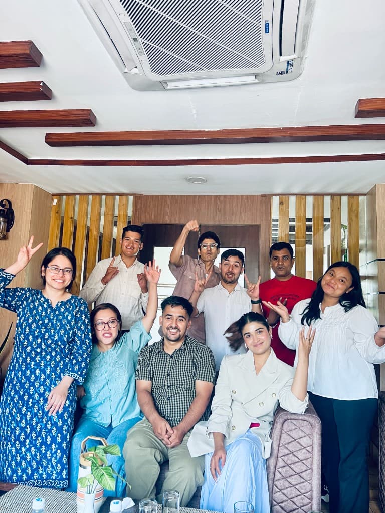 Prem Sapkota celebrating with a large group of colleagues and friends